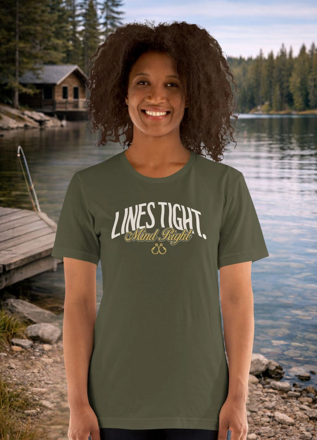 Woman wearing a green Fishing t-shirt with 'Lives Tight, Mind Right' text by a lake house.
